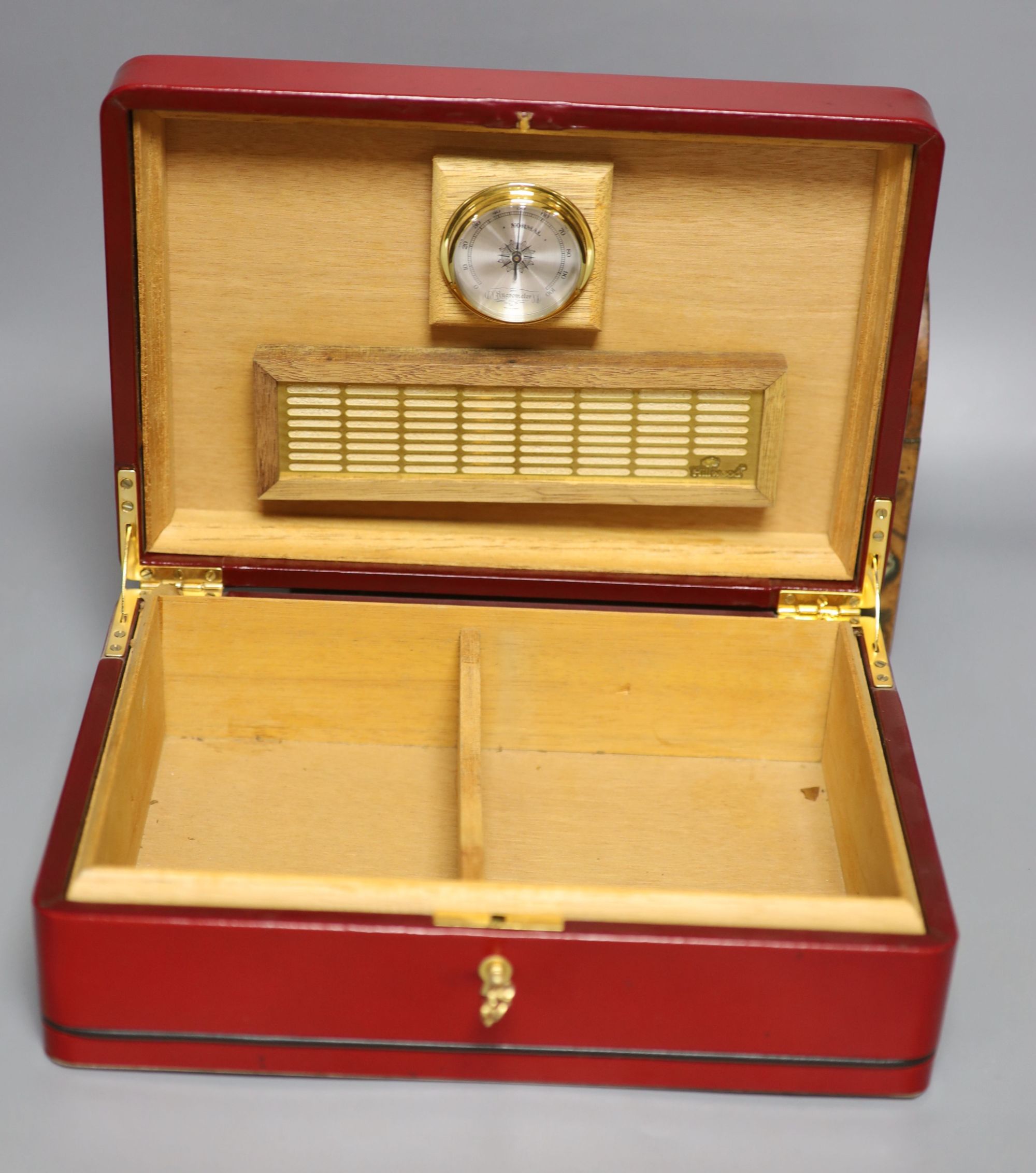 A Garrard rosewood and brass bound dome-topped box, a red leather humidor and a mahogany jewellery box